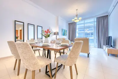 a dining room with a table and chairs at Manazel Al Safa in Dubai in Dubai