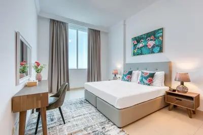 a hotel room with a bed and a desk and a desk at Manazel Al Safa in Dubai in Dubai