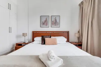 a bedroom with a large white bed with towels on it at GuestReady - Marina Views | 1BR + Pool & Gym in Dubai