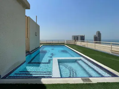 a swimming pool on the roof of a building at GuestReady - Marina Views | 1BR + Pool & Gym in Dubai
