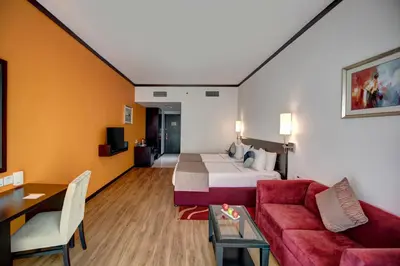 a hotel room with a bed and a couch at Grandeur Hotel Al Barsha in Dubai