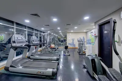 a gym with treadmills and elliptical machines at Grandeur Hotel Al Barsha in Dubai