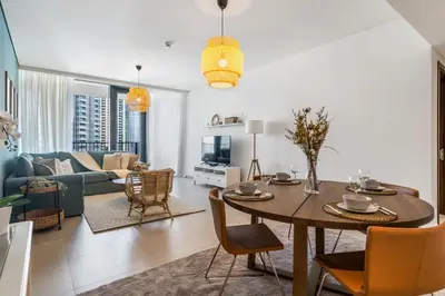 a living room with a table and a couch at High-End Chic Apartment, Close to Burj Khalifa in Dubai