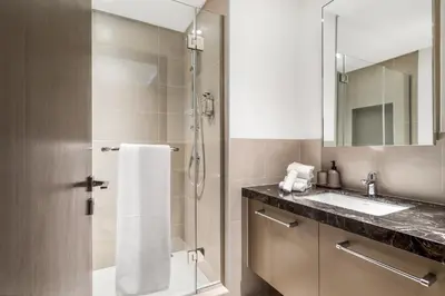 a bathroom with a shower and a sink at High-End Chic Apartment, Close to Burj Khalifa in Dubai