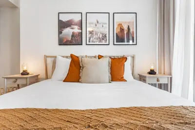 a bedroom with a large bed with orange pillows at High-End Chic Apartment, Close to Burj Khalifa in Dubai