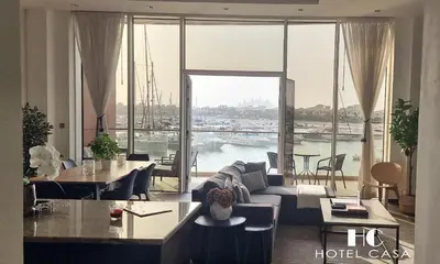 a living room with a couch and a large window at Palm Jumeirah 1BR luxurious & gorgeous view in Dubai