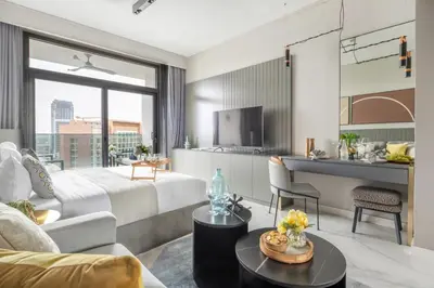 a hotel room with a king sized bed and a living room at Frank Porter - MAG 318 in Dubai