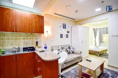 a kitchen and a living room with a couch at Luxury Escapes - Budget Cozy Studio in Dubai Gate 2 JLT in Dubai