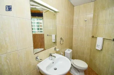 a bathroom with a sink and a toilet and a mirror at Luxury Escapes - Budget Cozy Studio in Dubai Gate 2 JLT in Dubai