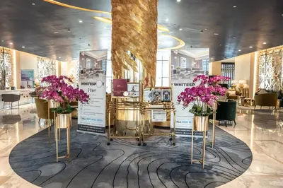 a room with three vases filled with purple flowers at AWS Holiday Homes - Panoramic Canal View in Dubai