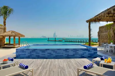 a swimming pool with a view of the ocean at Anantara World Islands Dubai Resort in Dubai