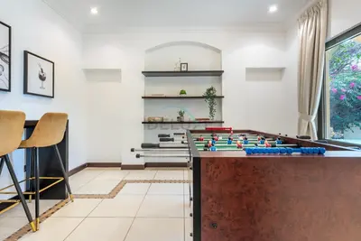 a living room with a foosball table at Luxury Beachfront Villa with Direct Beach Access, Next to Community Pool, Close to the Thrills of Aquaventure Waterpark, Canal Cove, Palm Jumeirah by Deluxe Holiday Homes in Dubai