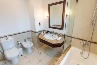 a bathroom with a sink and a toilet and a shower at Luxury Beachfront Villa with Direct Beach Access, Next to Community Pool, Close to the Thrills of Aquaventure Waterpark, Canal Cove, Palm Jumeirah by Deluxe Holiday Homes in Dubai