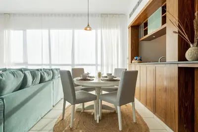 a dining room with a table and chairs at Chic and Zen Apartment, Near Burj Khalifa Tower in Dubai