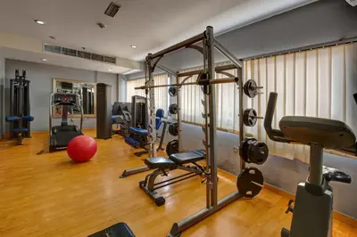 a gym with treadmills and exercise equipment in a room at Orchid Hotel Al Barsha 