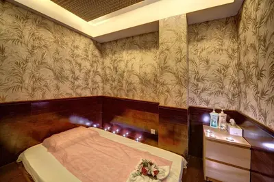 a bedroom with a bed and a wooden wall at Orchid Hotel Al Barsha 