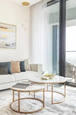 a living room with a couch and a table at Frank Porter - The Address JBR in Dubai