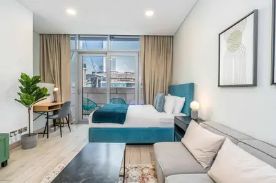 a hotel room with a bed and a couch at Silkhaus newly furnished studio facing DIFC with pool and gym access in Dubai
