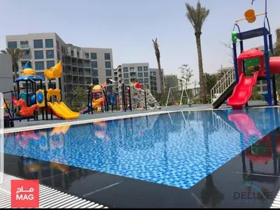 a swimming pool with a playground with a slide at Peaceful 1BR at MAG 505 Dubai South by Deluxe Holiday Homes in Dubai