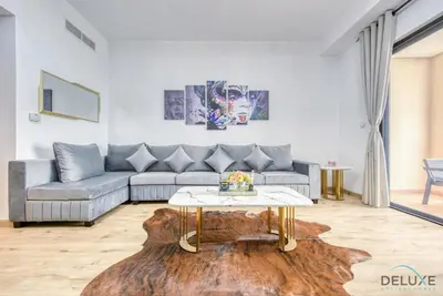 a living room with a couch and a coffee table at Elegant 2BR at Bahar 2 JBR by Deluxe Holiday Homes in Dubai
