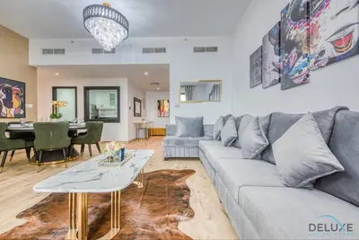 a living room with a couch and a table at Elegant 2BR at Bahar 2 JBR by Deluxe Holiday Homes in Dubai