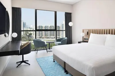 a hotel room with a bed and a desk at Courtyard by Marriott World Trade Centre, Dubai in Dubai