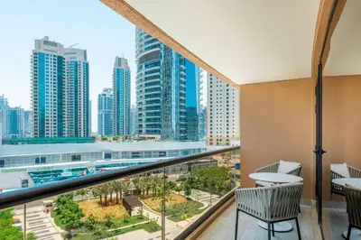 a balcony with a view of a city at Le Royal Meridien Beach Resort & Spa Dubai in Dubai