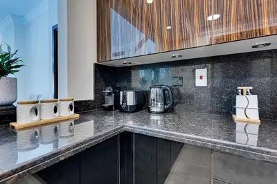 a kitchen with a counter top with a coffee maker at Fairmont Apartments The Palm, Free access to hotel beach and pools in Dubai