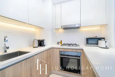 a kitchen with a sink and a stove at LUX Contemporary Suite with Marina View 6 in Dubai