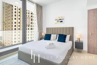a bedroom with a large bed and a large window at LUX Contemporary Suite with Marina View 6 in Dubai