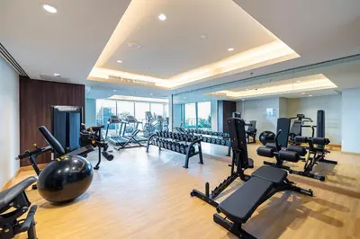a gym with a lot of treadmills and exercise equipment at Unlock J One Downtown Dubai in Dubai
