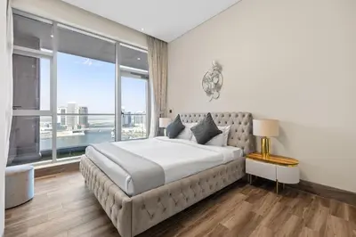 a bedroom with a large bed and a large window at Unlock J One Downtown Dubai in Dubai