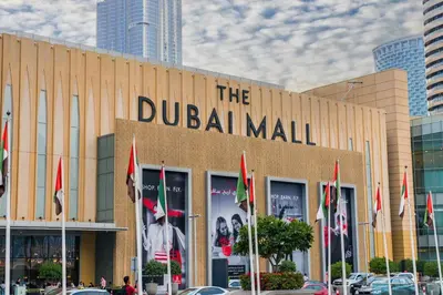 a building with the dublin mall with flags in front of it at Unlock J One Downtown Dubai in Dubai