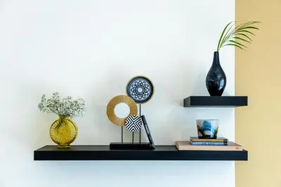a shelf with a clock and other items on it at Unlock Waters Edge in Dubai