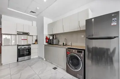 a kitchen with a washer and a dishwasher at Unlock Waters Edge in Dubai