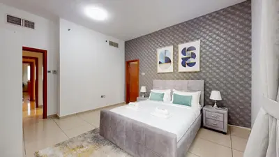 a bedroom with a large bed in a room at MP12 - Luxurious 2BR in Marina Pinnacle Tower in Dubai