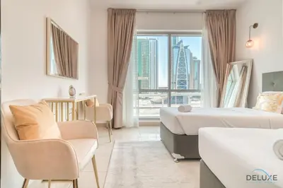 a hotel room with two beds and a view of a city at Classy 2BR at La Riviera Dubai Marina by Deluxe Holiday Homes in Dubai