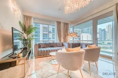 a living room with a couch and a tv at Classy 2BR at La Riviera Dubai Marina by Deluxe Holiday Homes in Dubai