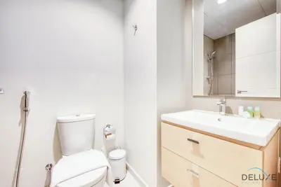 a bathroom with a toilet and a sink at Extensive 3BR Townhouse at Janusia Damac Hills 2 by Deluxe Holiday Homes in Dubai