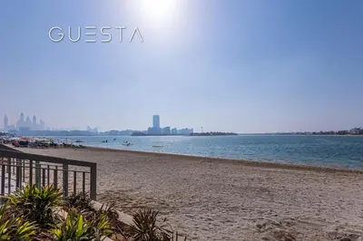 a beach with the city in the background at Azizi Mina The Palm, Free beach and pool access in Dubai