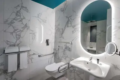 a white bathroom with a sink and a mirror at Hyatt Centric Jumeirah Dubai in Dubai