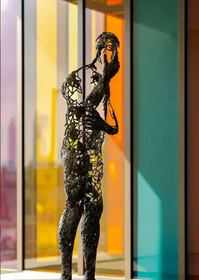 a statue of a woman standing in front of a window at Hyatt Centric Jumeirah Dubai in Dubai