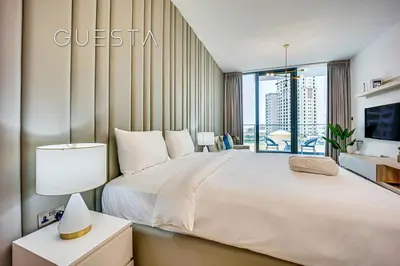 a bedroom with a large white bed and a window at LIV Residence, Dubai Marina in Dubai