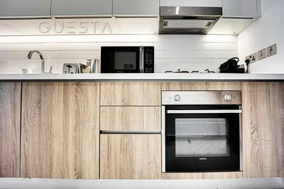 a kitchen with a stove and a microwave at LIV Residence, Dubai Marina in Dubai
