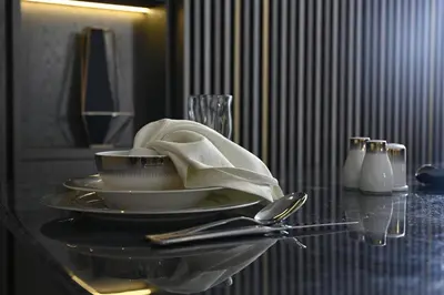 a table with a plate with a napkin on it at Smart Living Villa in Dubai