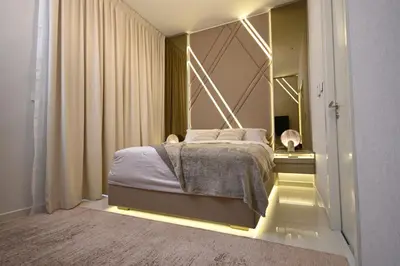 a bedroom with a bed with lights on it at Smart Living Villa in Dubai