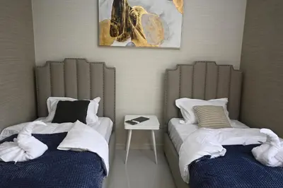 two beds sitting next to each other in a room at Smart Living Villa in Dubai