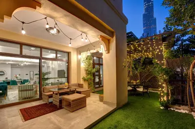 a home with a patio with a table and chairs at Durrani Homes - Arabian luxury at Souk Al Bahar besides Burj Khalifa & Dubai Mall in Dubai