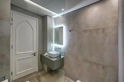 a bathroom with a sink and a white door at Durrani Homes - Arabian luxury at Souk Al Bahar besides Burj Khalifa & Dubai Mall in Dubai