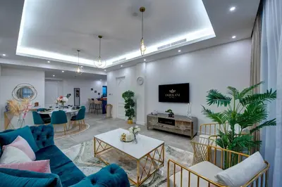 a living room with a blue couch and a table at Durrani Homes - Arabian luxury at Souk Al Bahar besides Burj Khalifa & Dubai Mall in Dubai